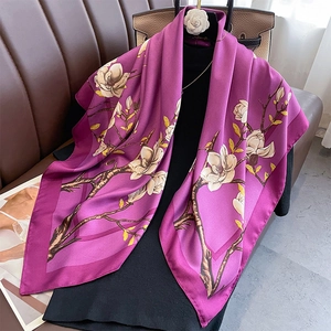 Macro detail of elegant silk shawl featuring realistic white magnolia flower prints