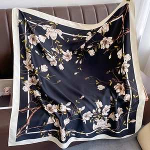 Close-up of vintage floral silk scarf with magnolia print and satin texture on leather