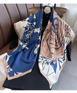 Detail of artistic floral silk scarf with hand-rolled edges on elegant dark background