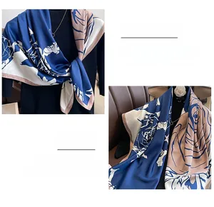 Detail of floral silk scarf showing smooth texture and high-quality hem stitching