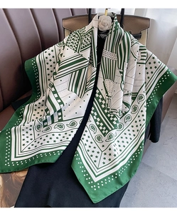 Détail d'un carré de soie de luxe avec imprimé paisley et équestre en vert forêt