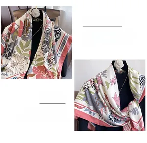 Detail of premium silk square scarf showing delicate hand-rolled edges and floral prints