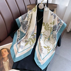 Floral print tiffany blue large silk square scarf shawl displayed on a fashion mannequin