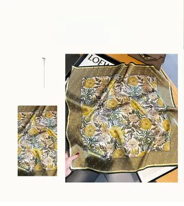 Detail of silk scarf with floral daisy patterns and geometric borders in vintage style