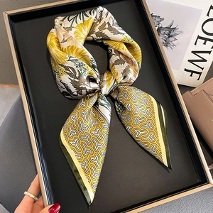 Elegant floral silk square scarf with yellow blossom patterns on a satin texture