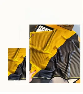 Detail of yellow and black striped 100% silk scarf with fine hand-rolled edges