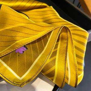Silk neck scarf with yellow and black stripes and purple cartoon elephant pattern