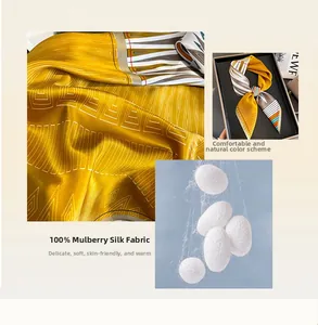 Detail of premium 100% mulberry silk scarf in ginger yellow with white geometric patterns
