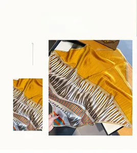 Detail of silk square scarf featuring ginger yellow modern geometric color block patterns