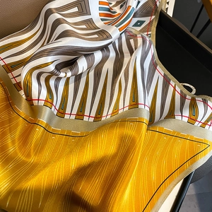 Elegant mulberry silk square scarf with geometric abstract patterns in bright yellow and grey