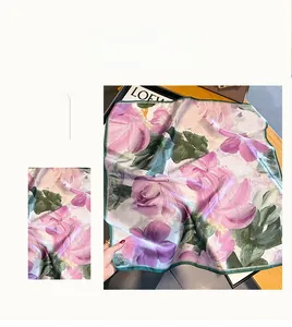 Detail of premium silk scarf featuring elegant floral patterns and a soft satin finish