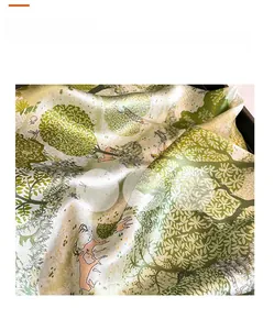 Detail view of mulberry silk scarf showing forest patterns with deer and fluid silk texture