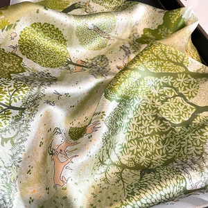 Silk forest theme scarf with deer and bird print featuring a glossy finish and soft drape