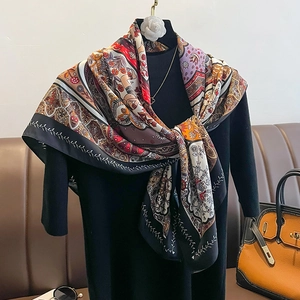 Detail of bohemian printed 90cm silk scarf styled on an elegant black turtleneck outfit
