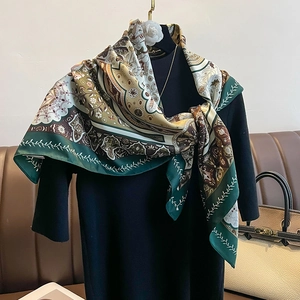 Baroque floral silk scarf in forest green and khaki draped on an elegant black suit