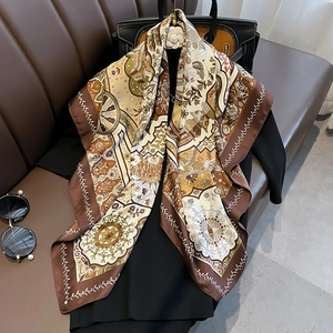 Retro mandala print 90cm silk scarf with earthy tones draped on a black dress