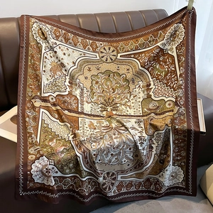 Detail of 90cm silk scarf with tree of life and mythological patterns on leather sofa