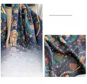 Close-up of vintage navy blue silk scarf with floral prints and reinforced edge detail
