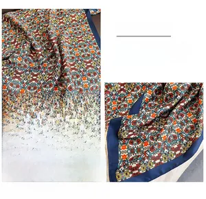 Detail of floral print silk scarf featuring premium hemmed edges and vibrant patterns