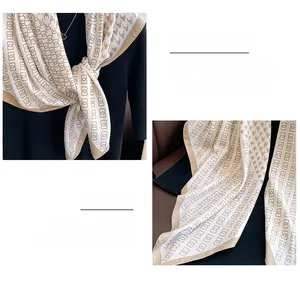 Detail of houndstooth silk scarf showing fine edge stitching and geometric pattern