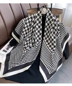 Detailed close-up of high-quality houndstooth pattern square scarf with silk texture