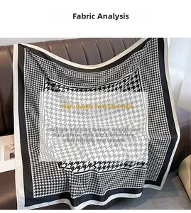 Detail of premium twill silk scarf with classic black and white houndstooth pattern texture