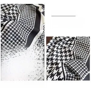Detailed view of the classic black and white houndstooth scarf with exquisite hemmed edges