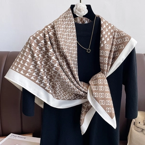 Detail of houndstooth silk scarf with elegant chain pattern and smooth satin texture