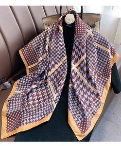 Close-up of classic houndstooth silk scarf with modern fashion letter print