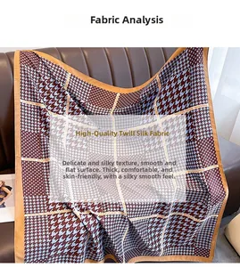 Detail of burgundy houndstooth silk scarf with orange borders on twill fabric texture