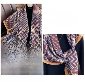 Close-up of classic houndstooth scarf showing modern fashion text and edge stitching