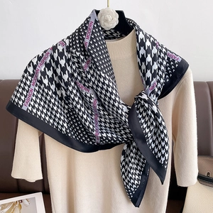 Detail of silk scarf with houndstooth pattern and Fashion Modern pink border text