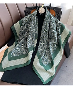 Detailed view of dark green silk scarf with vintage 1854 floral clover print