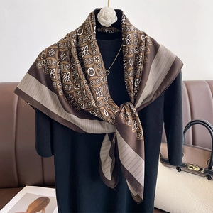 Vintage patterned silk square scarf in brown and beige draped on a model