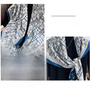 Detail of blue and white geometric twill silk scarf showing fine stitching and fashion motifs