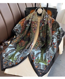 Detail of elegant 90cm twill silk scarf with tropical floral prints and rolled edges