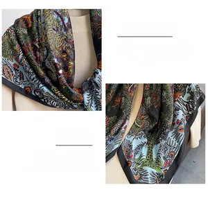 Detailed view of silk scarf featuring fine rolled edge stitching and floral pattern