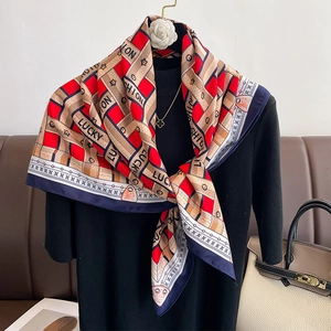 French style geometric silk scarf with red and blue stripes on a black sweater display