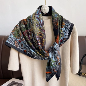 Elegant 90cm floral twill silk scarf with black border on a chic knit sweater