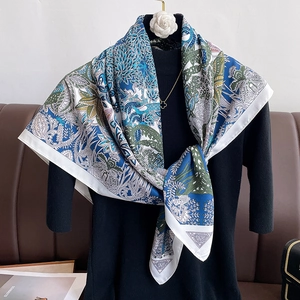Detailed view of 90cm silk scarf with vintage navy and green patterns on a mannequin