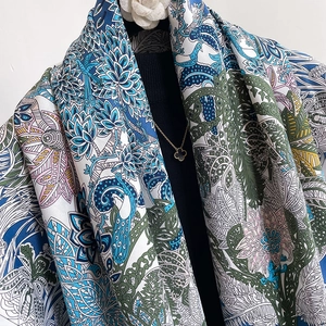 Detailed view of 90cm twill silk scarf with peacock floral print draped on a mannequin
