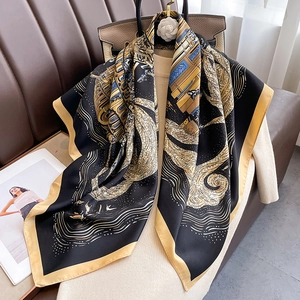 Detailed view of 90cm square silk scarf with geometric wavy patterns on a beige top