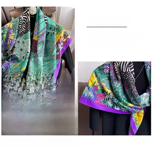 Detail shot of the fine stitching and vibrant floral zebra patterns on this silk scarf