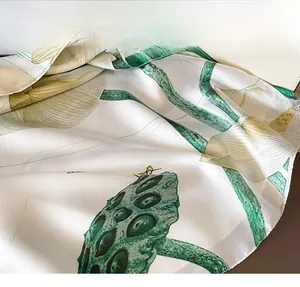 Detailed close-up showing the precise stitching and soft silk texture of the scarf