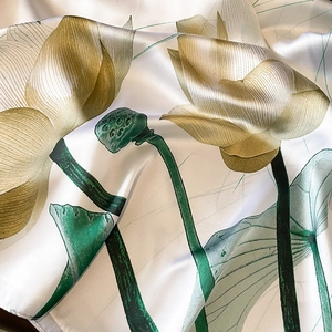 Silk satin scarf with elegant golden lotus and green lily pad prints on white background