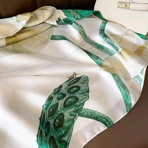 Lightweight silk scarf with lotus print and satin finish for summer sun protection