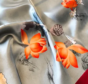 Detailed view of meticulous stitched edges on grey-blue lotus print silk scarf