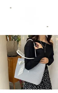 Close-up of woven blue and white checkered tote bag with decorative silk scarf handle
