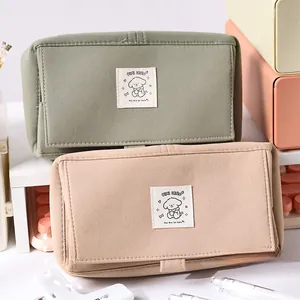 Detailed view of large capacity canvas pencil cases in matcha green and milk tea brown