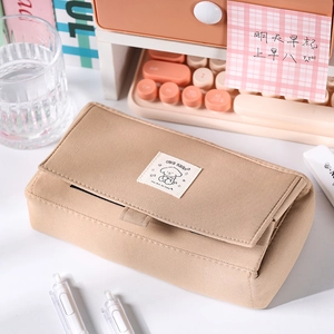 Detail of khaki canvas pencil case showing the cute cartoon dog patch and flip-top cover